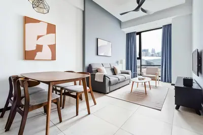 a living room with a table and a couch at Blueground Kuala Lumpur city view nr KL Bird Park KUL-2 in Kuala Lumpur