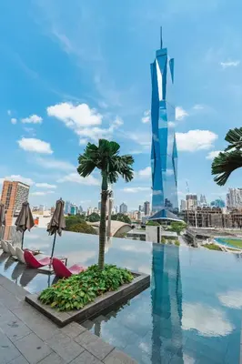 a pool with a palm tree on the roof of a building at Blueground Kuala Lumpur pool nr KL Bird Park KUL-3 in Kuala Lumpur