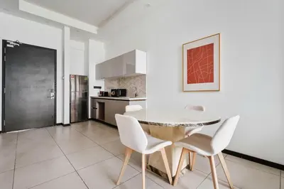 a kitchen with a table and chairs in a room at Blueground Kuala Lumpur pool nr Titiwangsa Park KUL-4 in Kuala Lumpur