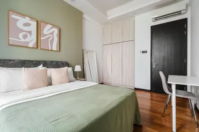 a bedroom with a bed with a table and a desk at Blueground Kuala Lumpur pool nr Titiwangsa Park KUL-4 in Kuala Lumpur