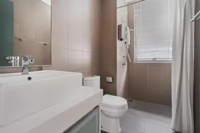 a bathroom with a toilet and a sink and a mirror at Blueground Kuala Lumpur pool nr KL Tower KUL-5 in Kuala Lumpur