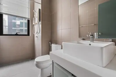 a bathroom with a sink and a toilet and a mirror at Blueground Kuala Lumpur pool nr KL Tower KUL-5 in Kuala Lumpur