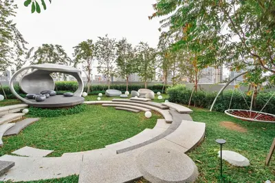 a garden with a bench and a playground at Blueground Kuala Lumpur rooftop pool nr KLCC KUL-6 in Kuala Lumpur
