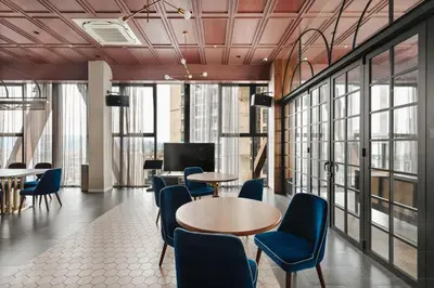 a lobby with tables and chairs and windows at Blueground Kuala Lumpur rooftop pool nr KLCC KUL-6 in Kuala Lumpur