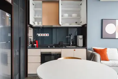 a kitchen with a white table and a couch at Blueground Kuala Lumpur rooftop pool nr KLCC KUL-7 in Kuala Lumpur