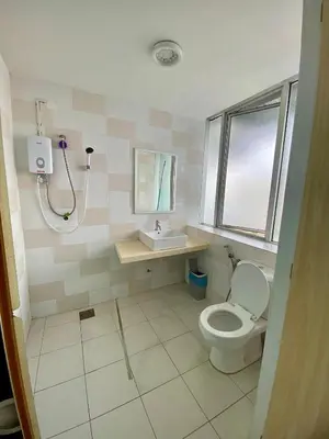 a bathroom with a toilet and a sink at nuvea Suites in Kuala Lumpur