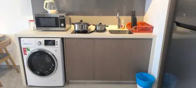 a kitchen with a washing machine and a microwave at Agile Twilight Residence Apartment in Kuala Lumpur