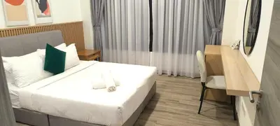 a bedroom with a bed and a table and a chair at Agile Twilight Residence Apartment in Kuala Lumpur