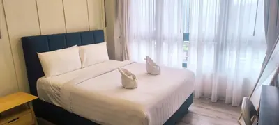 a bedroom with a bed with two shoes on it at Agile Twilight Residence Apartment in Kuala Lumpur
