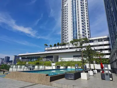 a building with a swimming pool in front of a tall building at 01 Kuala Lumpur KL Mid Valley The Garden 9Seputeh Vivo Soho 2PAX in Kuala Lumpur
