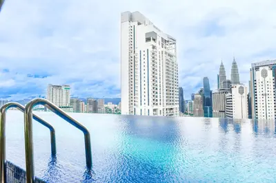 a swimming pool on top of a city skyline at Luxury couple suite Majestic Residence KLCC in Kuala Lumpur