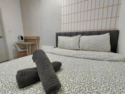 a bedroom with a bed with a gray blanket on it at KLCC Modern Stay, Majestic Residence, 2-5Pax in Kuala Lumpur