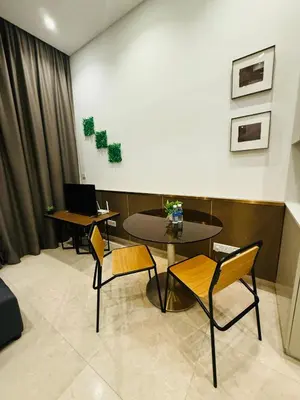 a room with two tables and a table with chairs at Lucentia Cozy Comfort Infinity Pool Suites in Kuala Lumpur