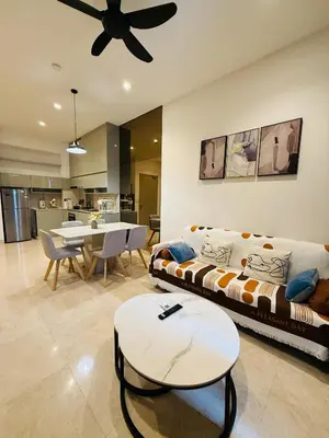 a living room with a couch and a table at Lucentia Cozy Comfort Infinity Pool Suites in Kuala Lumpur