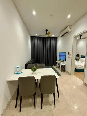 a dining room with a table and chairs and a bedroom at Lucentia Cozy Comfort Infinity Pool Suites in Kuala Lumpur