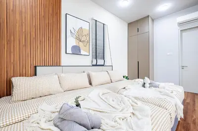 a bedroom with a large bed with a blanket at Isola KLCC By Feel Home in Kuala Lumpur