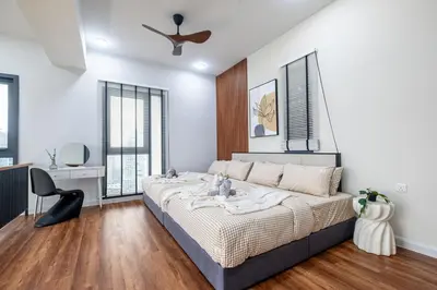 a bedroom with a large bed and a ceiling fan at Isola KLCC By Feel Home in Kuala Lumpur