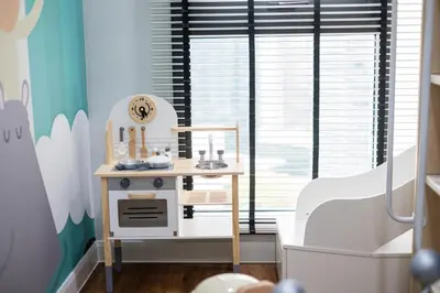 a childs play area with a pretend play kitchen in a room at Isola KLCC By Feel Home in Kuala Lumpur