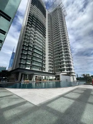 a large building with a pool in front of it at Suit Unit at Dua Sentral in Kuala Lumpur