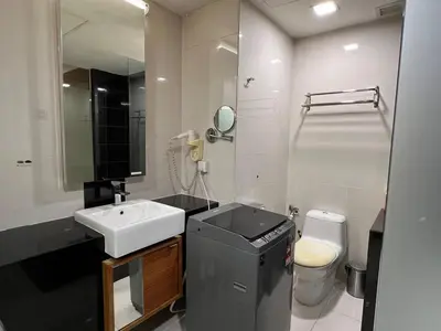 a bathroom with a sink and a toilet and a mirror at Suit Unit at Dua Sentral in Kuala Lumpur