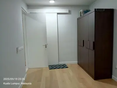 a room with a sliding door and a wooden cabinet at Sentral Residency KL sentral in Kuala Lumpur
