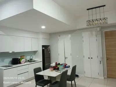 a kitchen with a table and chairs in a room at Sentral Residency KL sentral in Kuala Lumpur