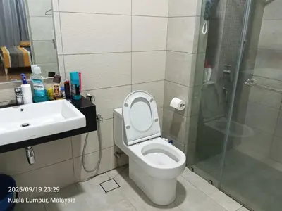 a bathroom with a toilet and a sink and a shower at Sentral Residency KL sentral in Kuala Lumpur