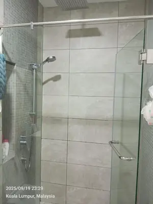 a shower with a glass door in a bathroom at Sentral Residency KL sentral in Kuala Lumpur