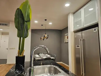 a kitchen with a sink and a dining table at Cozy Spacious Loft St Mary Bukit Bintang Pavilion in Kuala Lumpur
