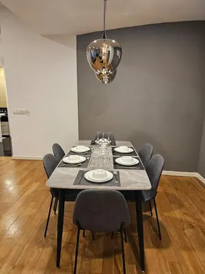a dining room table with chairs and a chandelier at Cozy Spacious Loft St Mary Bukit Bintang Pavilion in Kuala Lumpur