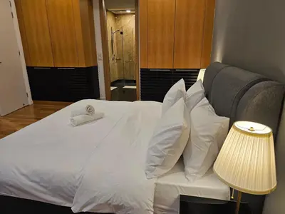 a white bed with a white towel on top of it at Cozy Spacious Loft St Mary Bukit Bintang Pavilion in Kuala Lumpur