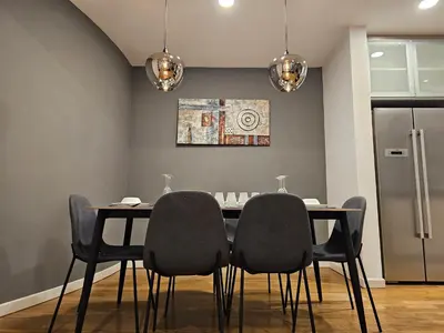 a dining room with a table and four chairs at Cozy Spacious Loft St Mary Bukit Bintang Pavilion in Kuala Lumpur