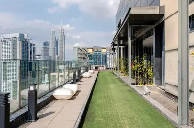 a balcony with grass on the side of a building at Luxury Living Hostel in Kuala Lumpur