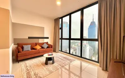 a living room with a couch and a large window at The Heart in Kuala Lumpur City - Majestic Residences in Kuala Lumpur