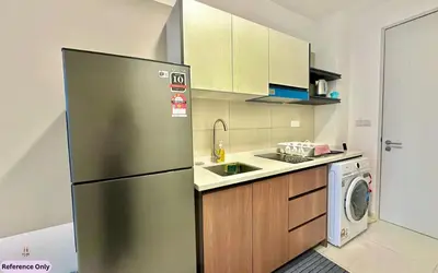 a kitchen with a stainless steel refrigerator and a dishwasher at The Heart in Kuala Lumpur City - Majestic Residences in Kuala Lumpur