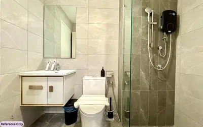 a bathroom with a shower and a toilet and a sink at The Heart in Kuala Lumpur City - Majestic Residences in Kuala Lumpur