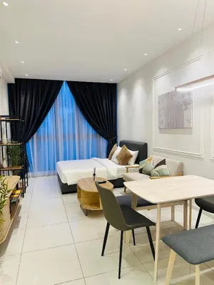a hotel room with a bed and a table and chairs at Majestic Residence KL in Kuala Lumpur