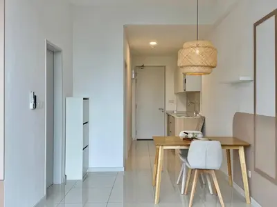 a dining room with a wooden table and a chair at Majestic Residence KL in Kuala Lumpur
