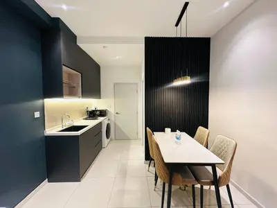 a kitchen and dining room with a table and chairs at Majestic Residence KL in Kuala Lumpur