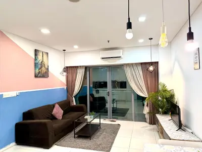 a living room with a couch and a tv at Kuala Lumpur City Center By Summer Suites in Kuala Lumpur