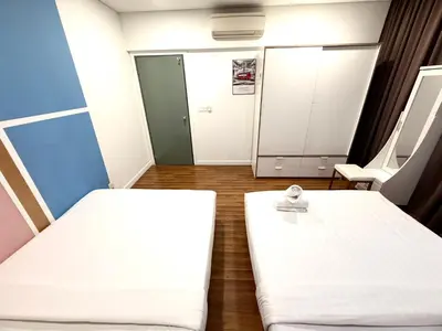 a hospital room with two beds and a mirror at Kuala Lumpur City Center By Summer Suites in Kuala Lumpur