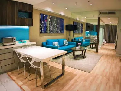 a living room with a blue couch and a table at Super Tang Jaya in Kuala Lumpur