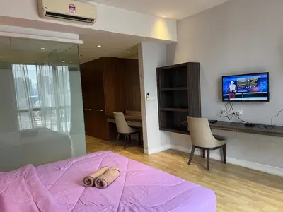 a bedroom with a dog laying on a bed at Super Tang Jaya in Kuala Lumpur