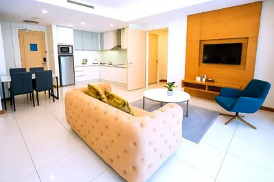 a living room with a couch and a table at Cormar Residences Kuala Lumpur in Kuala Lumpur