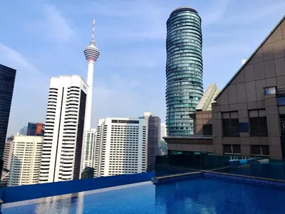 a view of theuckland city skyline from a swimming pool at Cormar Residences Kuala Lumpur in Kuala Lumpur