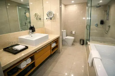 a bathroom with a sink and a shower and a toilet at Cormar Residences Kuala Lumpur in Kuala Lumpur