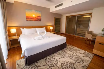 a hotel room with a bed and a large window at Cormar Residences Kuala Lumpur in Kuala Lumpur