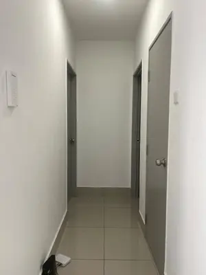 an empty hallway with two doors and a tile floor at Warm & Spacious 2BR Apartment in Kuala Lumpur