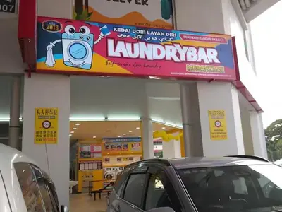 a car parked in front of a laundromat at Warm & Spacious 2BR Apartment in Kuala Lumpur
