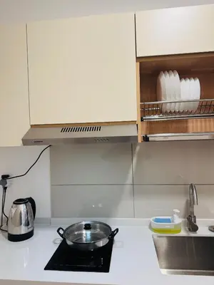 a kitchen counter with a frying pan on a stove at Majestic Serviced Suites KLCC in Kuala Lumpur